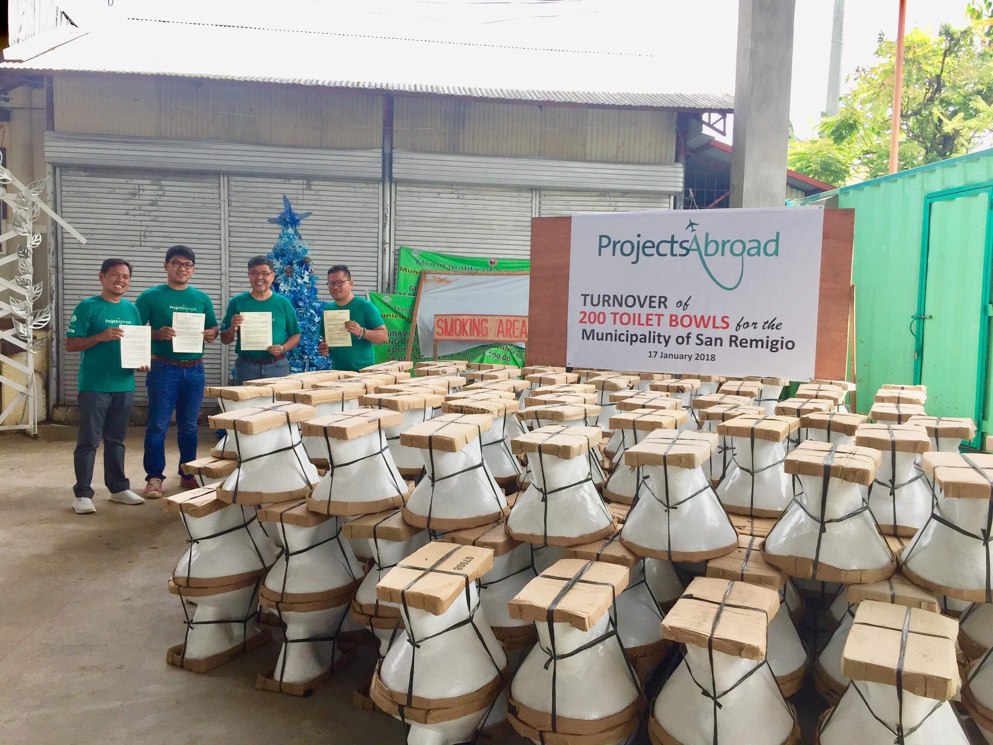 Projects Abroad teenage volunteers doing construction work in the Philippines deliver 200 toilet bowls to the local community. Teenage volunteers doing building work in the Philippines hand over 200 toilet bowls to a local community.